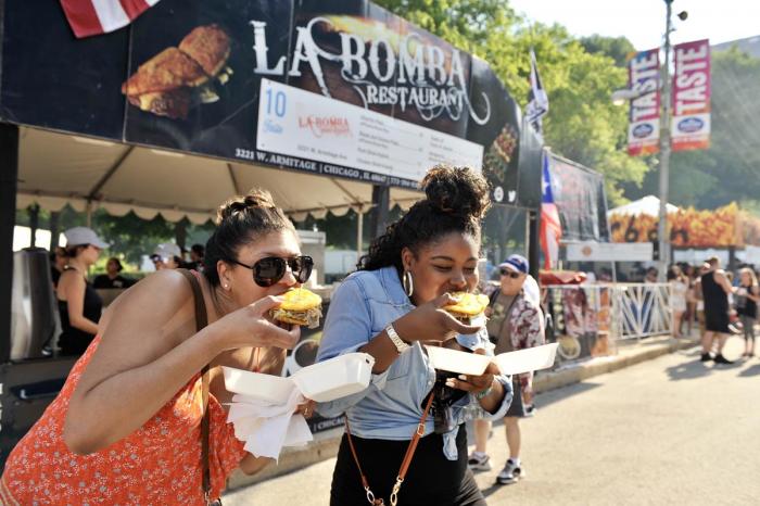 Two women eating at Taste of Chicago