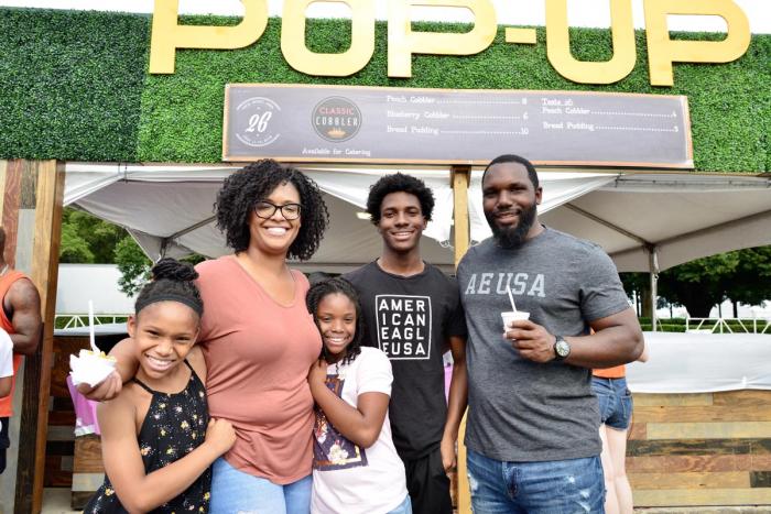 Family in front of pop-up restaurants at Taste of Chicago