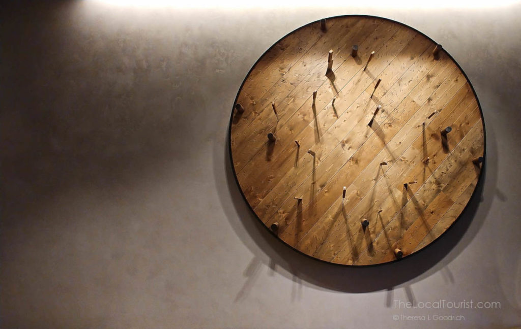 Knives impaled in giant spinning wooden disc in the lobby of Hotel Julian