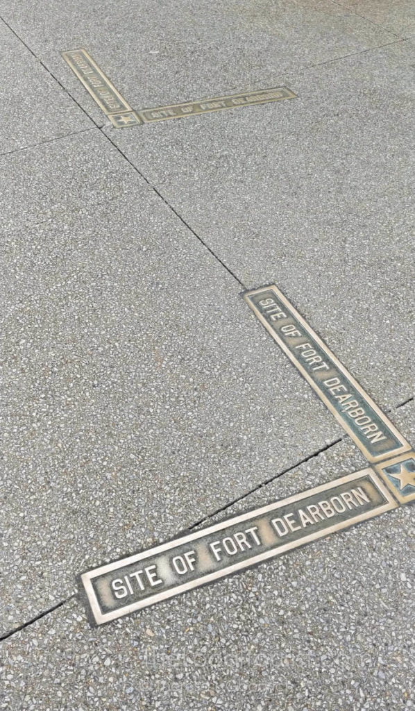 Fort Dearborn brass markers embedded in sidewalk mark the location of the historic fort